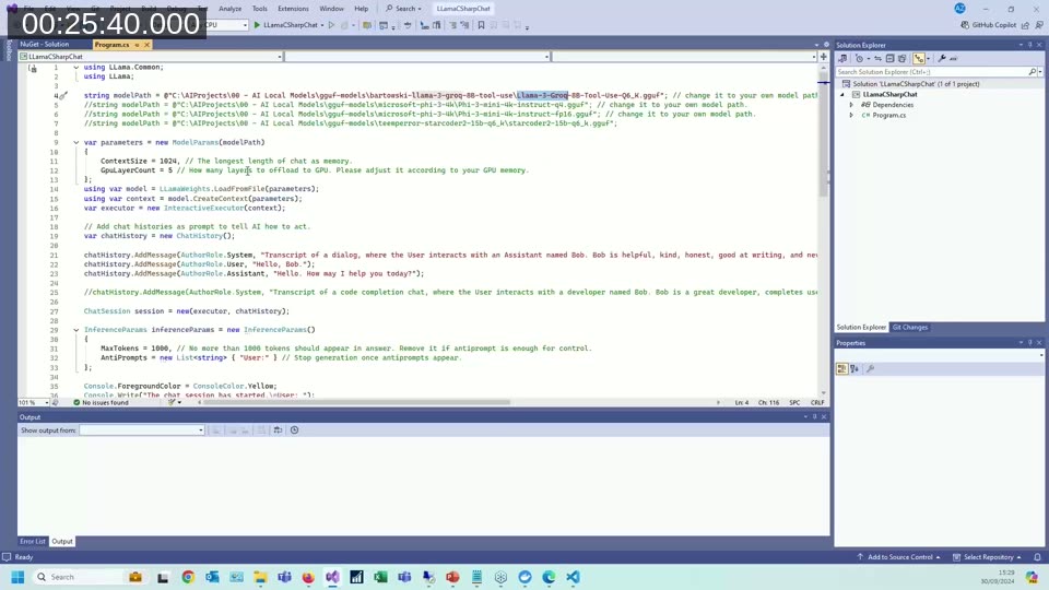 C# code in Visual Studio showing LlamaSharp model initialization, chat history setup with system and user messages, and async token streaming loop